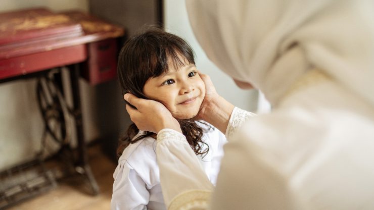 Muslim child and mother share a happy and meaningful moment