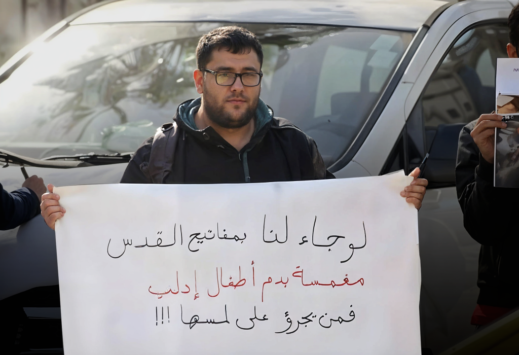 A Palestinian holding a placard reportedly in Ramallah, West Bank, Palestine